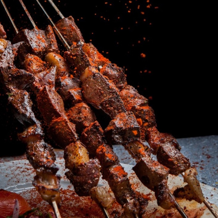 Flame-grilled meat and vegetable skewers served on a slate platter at Bodrum Kebab House in Hawick  